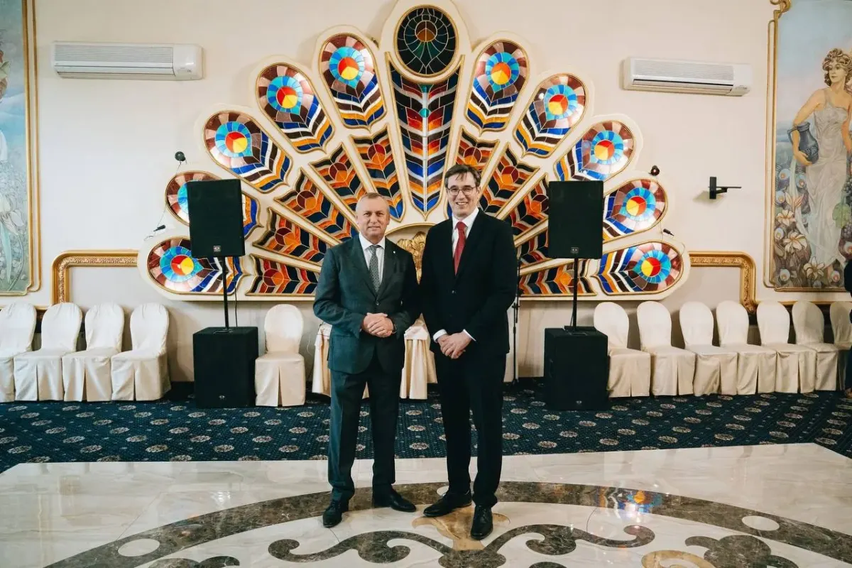 Two men in suits standing in a decorated hall for longevity retreat coordination content Two men in suits standing in a decorated hall for longevity retreat coordination content